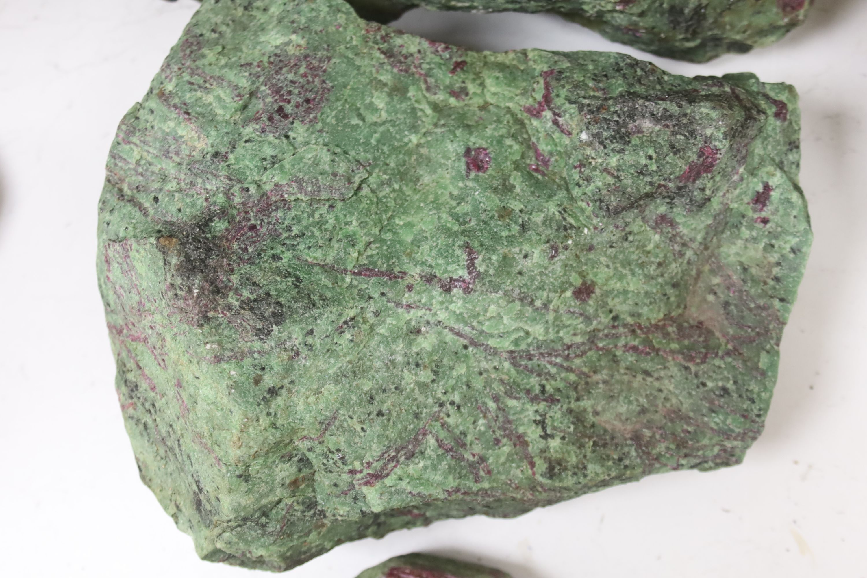 Three fragments of Anyolite (or ruby in zoisite) originating from a ruby mine in Kenya, largest 32 x 22cm